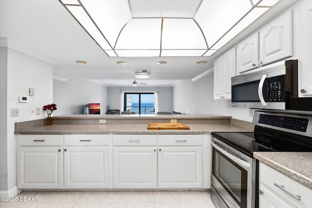 kitchen with ceiling fan, kitchen peninsula, white cabinetry, ornamental molding, and stainless steel appliances