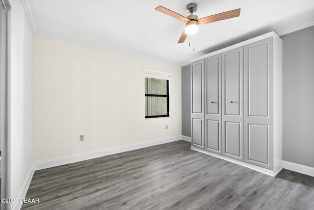 unfurnished bedroom featuring ceiling fan, wood-type flooring, and ornamental molding