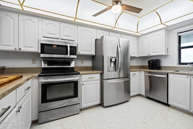 kitchen featuring stainless steel appliances, white cabinets, and sink