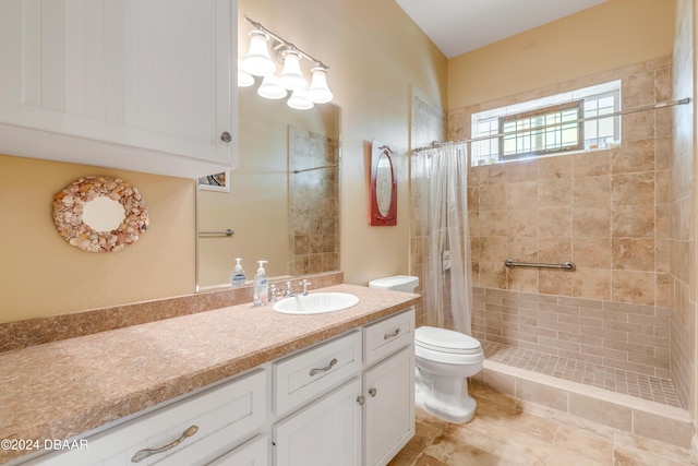 bathroom with a shower with shower curtain, vanity, and toilet