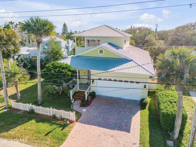 view of front of home with a front lawn and a garage