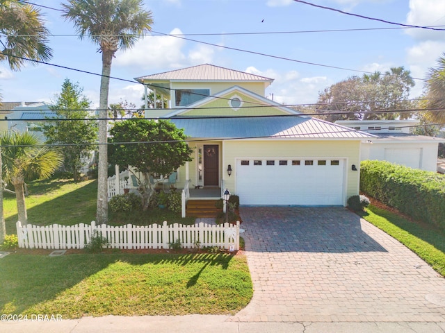 view of front of house featuring a front yard and a garage