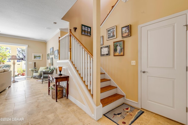 stairway featuring crown molding