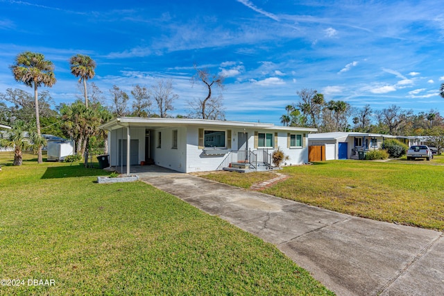 ranch-style home featuring a front lawn and a carport