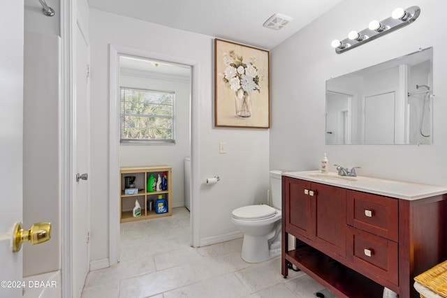 bathroom featuring tile patterned floors, vanity, and toilet