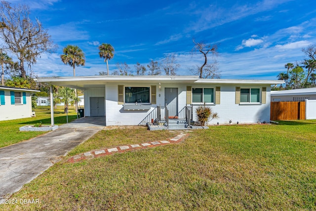 ranch-style house with a front lawn and a carport