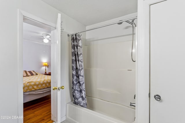 bathroom featuring shower / bath combo, hardwood / wood-style flooring, and ceiling fan