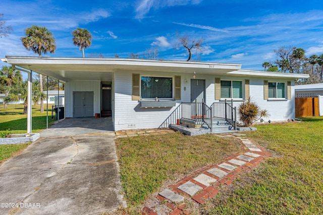 ranch-style home with a front yard and a carport