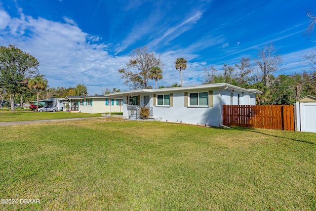 ranch-style house with a front lawn