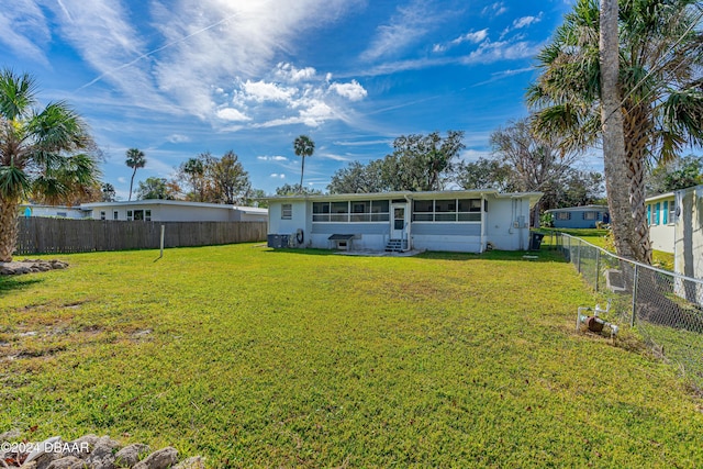 back of property featuring a yard