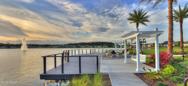 view of dock featuring a water view and a pergola