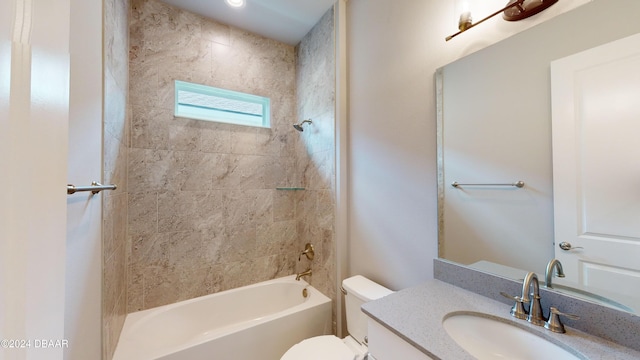 full bathroom featuring toilet, tiled shower / bath combo, and vanity