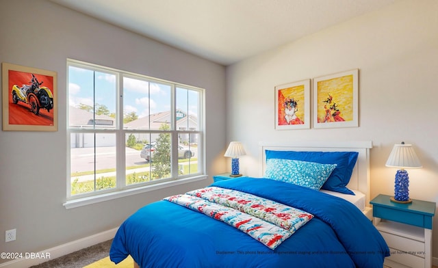 carpeted bedroom featuring multiple windows