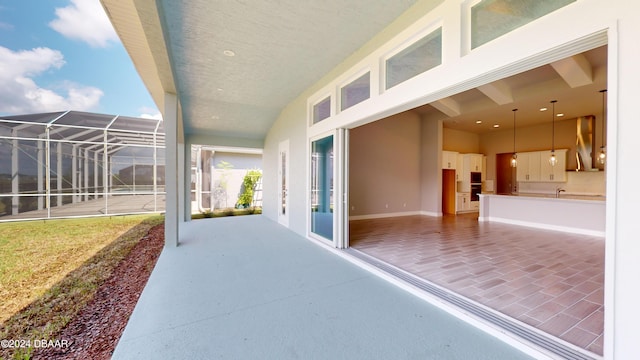 view of patio with glass enclosure