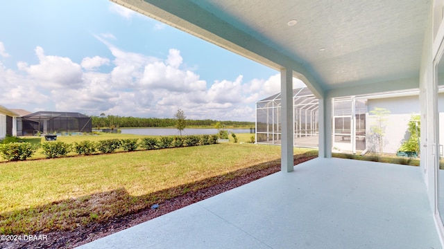 view of patio / terrace with a lanai and a water view