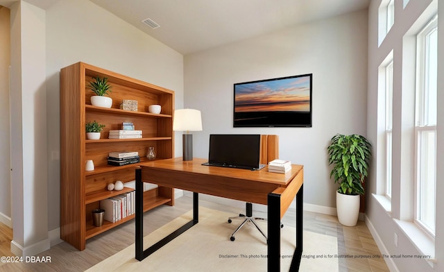 office featuring a healthy amount of sunlight and light hardwood / wood-style flooring