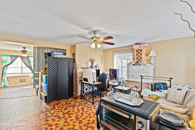 living room featuring a wealth of natural light and ceiling fan