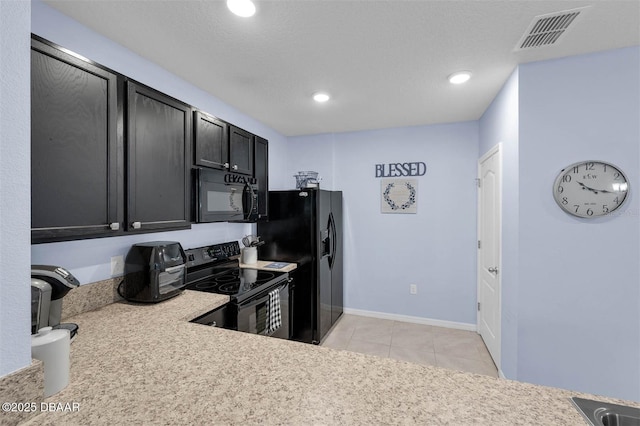 1615 Primo Ct, Holly Hill, FL 32117 - kitchen featuring black appliances, light countertops, dark cabinets, light tile patterned flooring, and recessed lighting