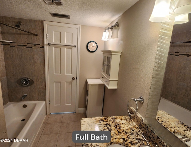 bathroom featuring tile patterned flooring, visible vents, a textured ceiling, and shower / tub combination