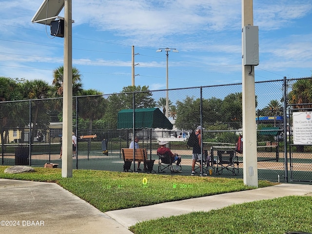 view of community featuring a yard and fence