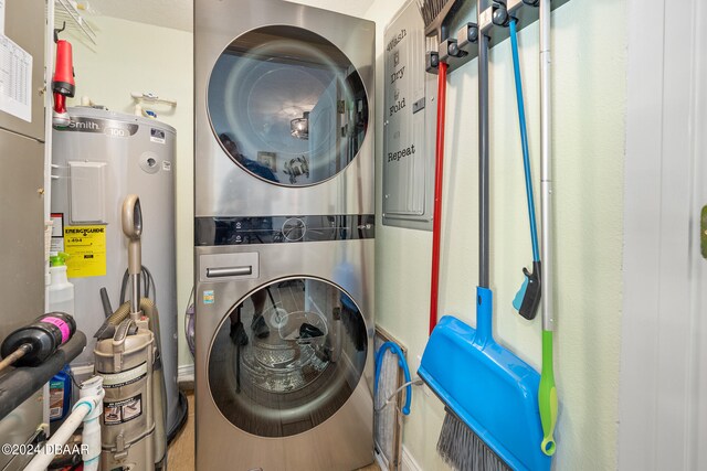 711 N Halifax Ave Unit 405, Daytona Beach, FL 32118 - laundry room featuring stacked washer / dryer and water heater