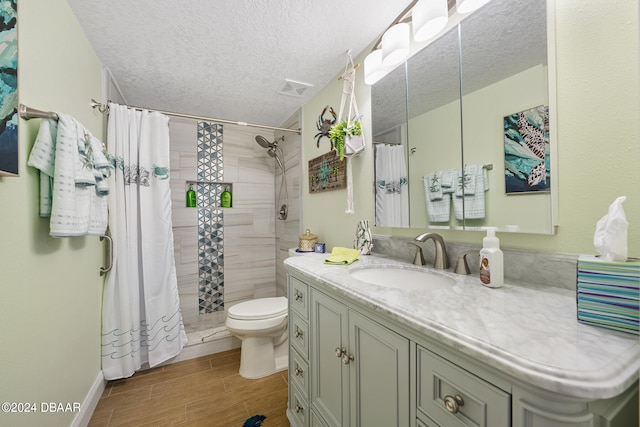 711 N Halifax Ave Unit 405, Daytona Beach, FL 32118 - bathroom featuring toilet, vanity, a textured ceiling, and curtained shower