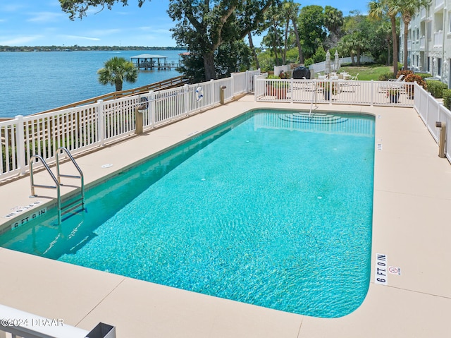 711 N Halifax Ave Unit 405, Daytona Beach, FL 32118 - view of pool featuring a water view and a patio