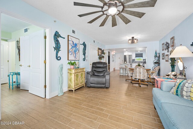 711 N Halifax Ave Unit 405, Daytona Beach, FL 32118 - living room with ceiling fan and light hardwood / wood-style flooring