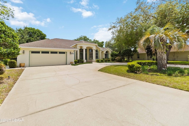 1320 Antrim Cir, Ormond Beach, FL 32174 - mediterranean / spanish-style house featuring stucco siding, an attached garage, and concrete driveway