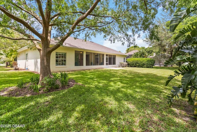 1320 Antrim Cir, Ormond Beach, FL 32174 - back of house featuring stucco siding and a lawn