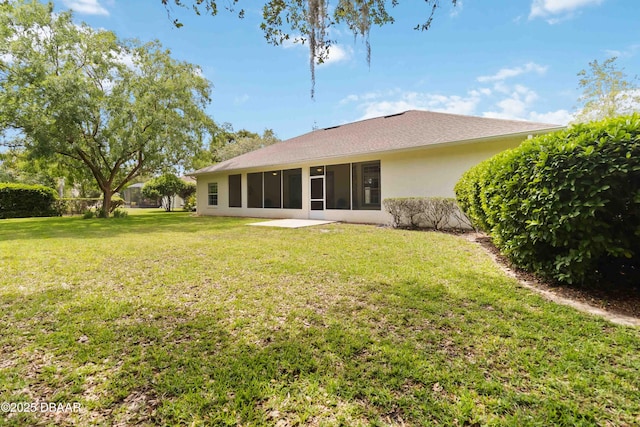 1320 Antrim Cir, Ormond Beach, FL 32174 - back of property with a lawn, a sunroom, and stucco siding