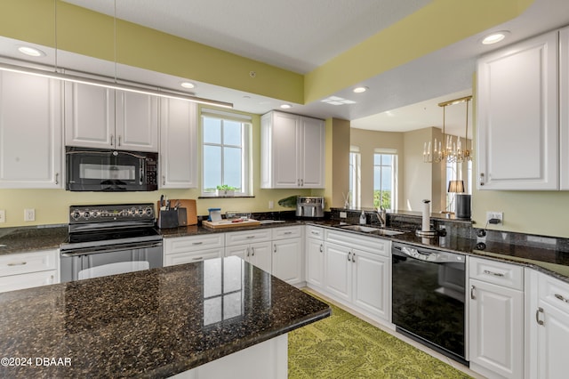 kitchen with a wealth of natural light, white cabinetry, and black appliances