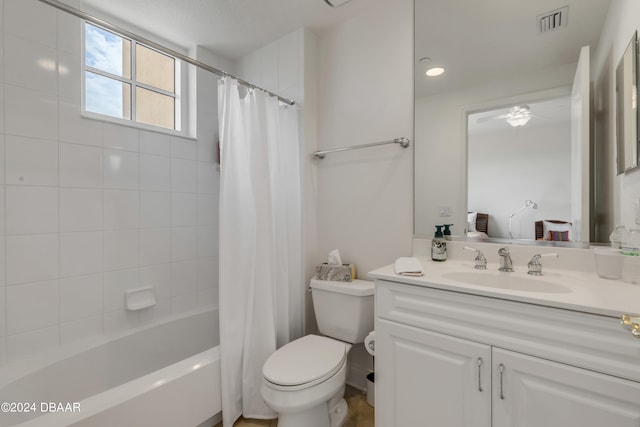 full bathroom with toilet, vanity, shower / bath combo with shower curtain, and ceiling fan