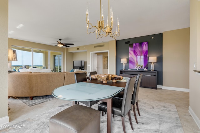 tiled dining room with ceiling fan with notable chandelier