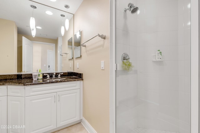 bathroom featuring a shower with shower door and vanity