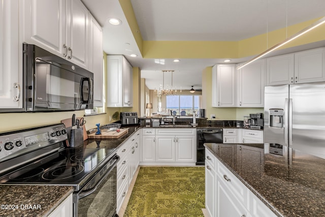 kitchen featuring white cabinets, black appliances, sink, hanging light fixtures, and dark stone countertops