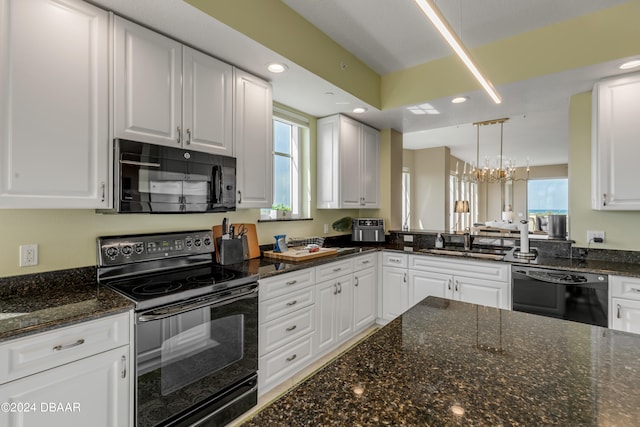 kitchen featuring white cabinets, black appliances, and decorative light fixtures