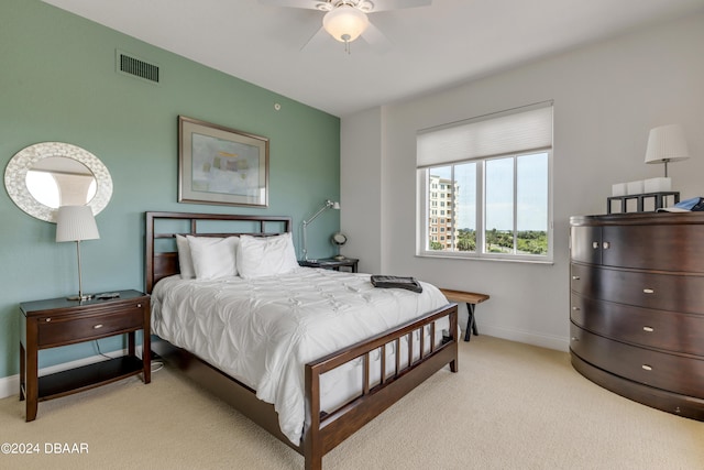 bedroom with ceiling fan and light colored carpet