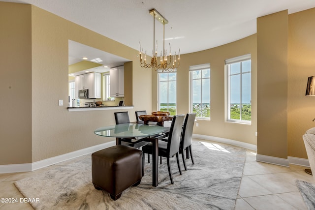 dining space featuring light tile patterned flooring and a chandelier