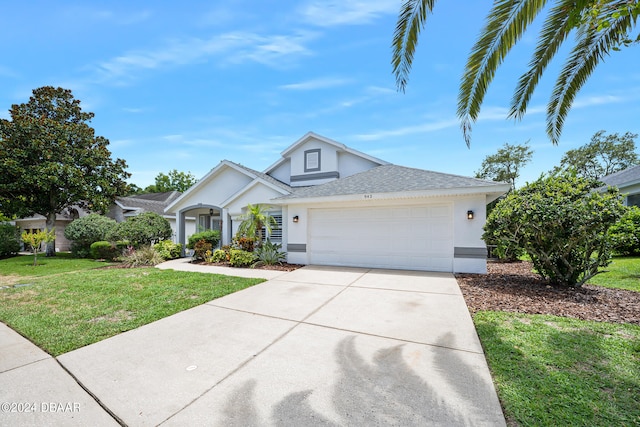 view of front of home with a garage and a front lawn