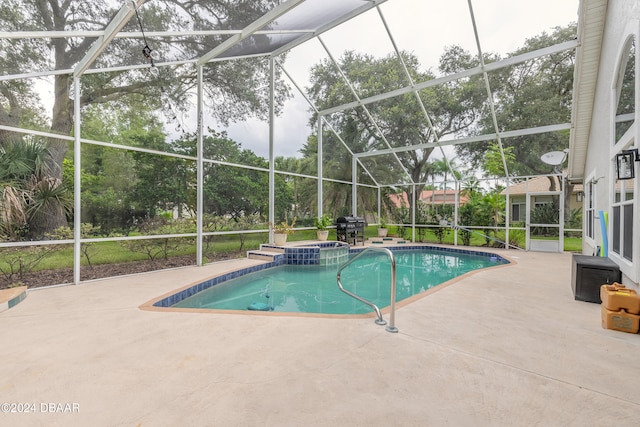 view of pool with a lanai, area for grilling, a patio, and an in ground hot tub