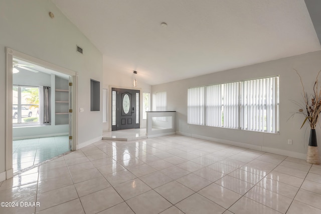 foyer entrance featuring lofted ceiling, light tile patterned floors, ceiling fan, and plenty of natural light