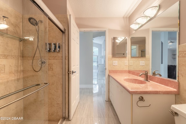 bathroom featuring walk in shower, vanity, a textured ceiling, and toilet