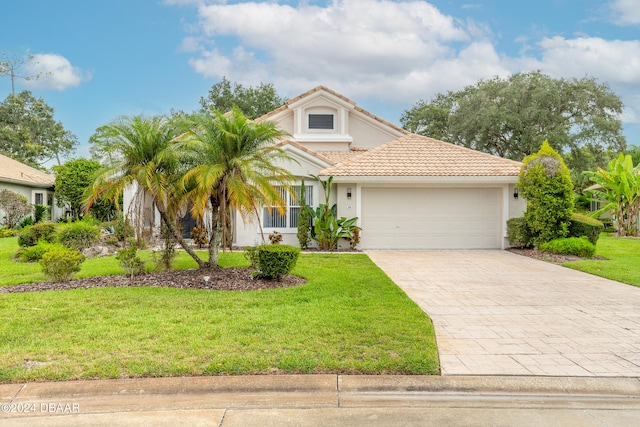 mediterranean / spanish-style house with a front lawn and a garage