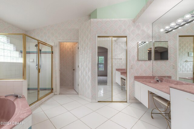 bathroom featuring independent shower and bath, tile patterned floors, and vaulted ceiling