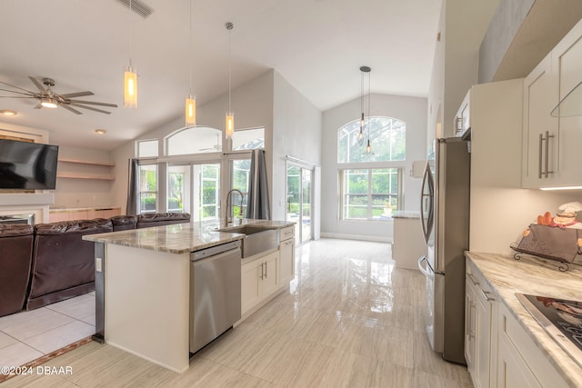 kitchen featuring white cabinets, hanging light fixtures, and stainless steel appliances