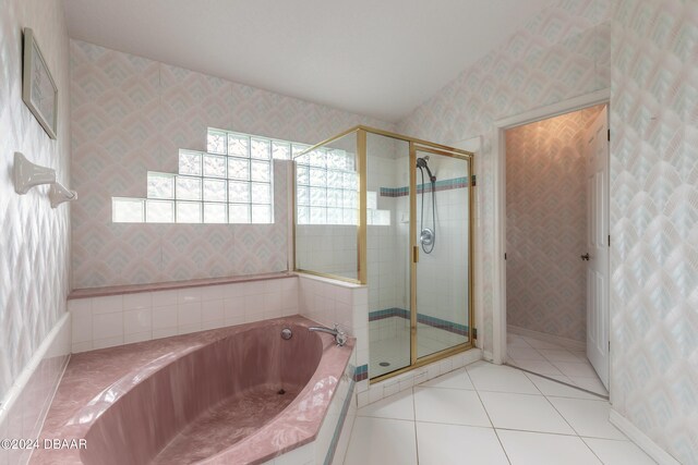 bathroom featuring tile patterned flooring and plus walk in shower