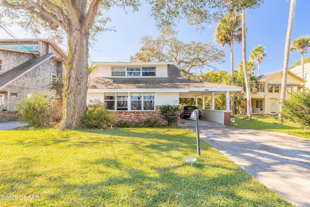 view of front of house with a front lawn and a carport