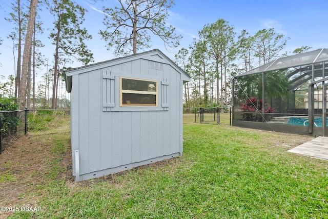 view of outbuilding with a fenced in pool and a lawn