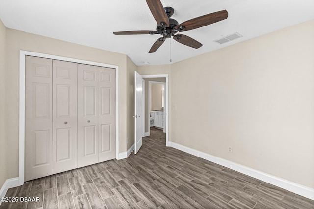 unfurnished bedroom featuring hardwood / wood-style flooring, a closet, and ceiling fan